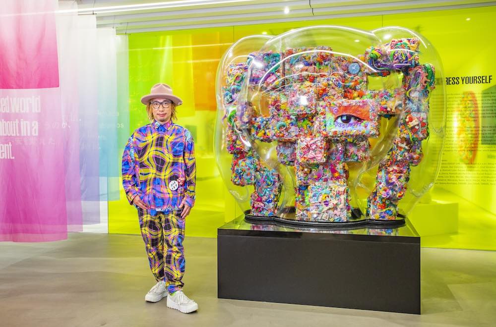 Artist Sebastian Masuda stands next to his newest piece Express Yourself