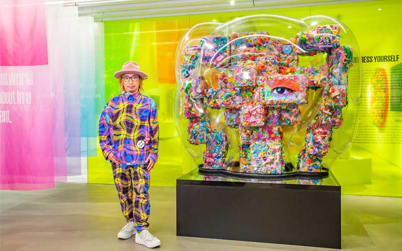 Artist Sebastian Masuda stands next to his newest piece “Express Yourself”