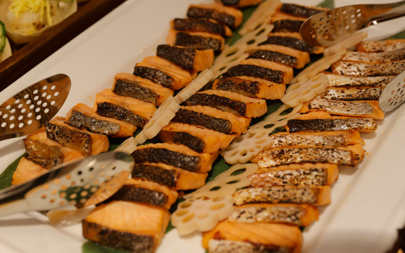 Grilled, sliced salmon fillets on a plate