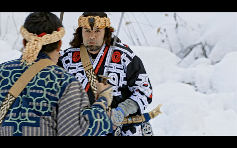 A scene from the documentary film “Ripples of Physis”. Two men facing each other with swords in hand.