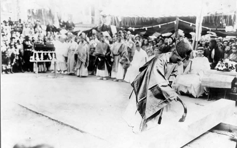 A black and white photo of a ritual at a Japanese shrine/temple