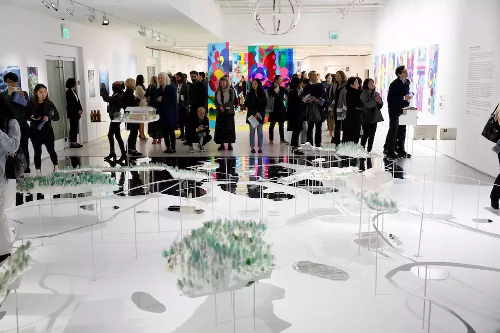 A crowd gathered to view the Inujima dioramas during the exhibition preview of Symbiosis: Living Island