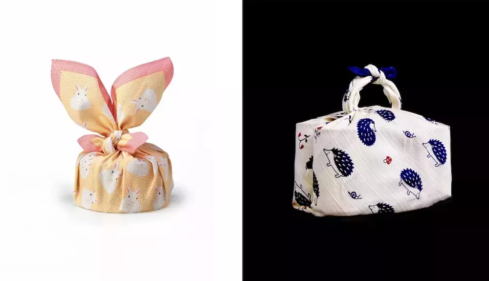 Furoshiki wrapped around bento boxes. Left furoshiki decorated with rabbits, right furoshiki decorated with hedgehogs