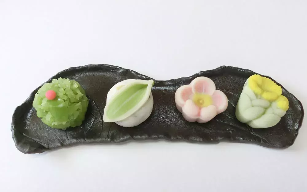 A variety of wagashi (Japanese traditional sweets) on a black plate