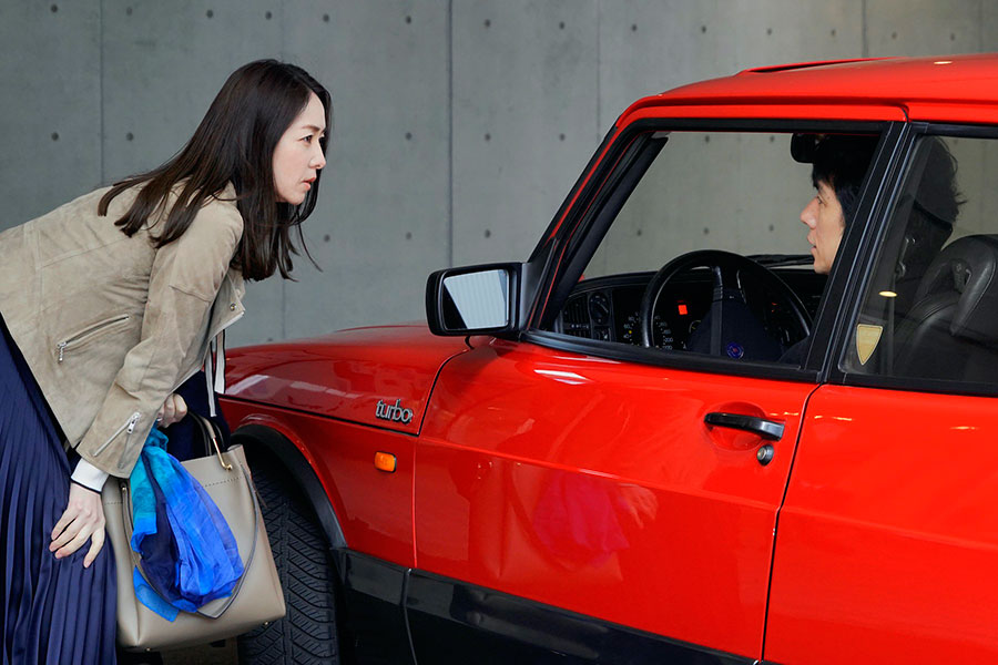 Reika Kirishima and Hidetoshi Nishijima with a red car